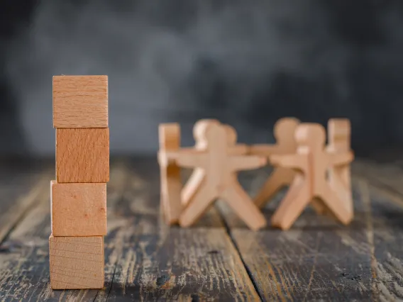 Group of figurines in circle, blocks stacked up