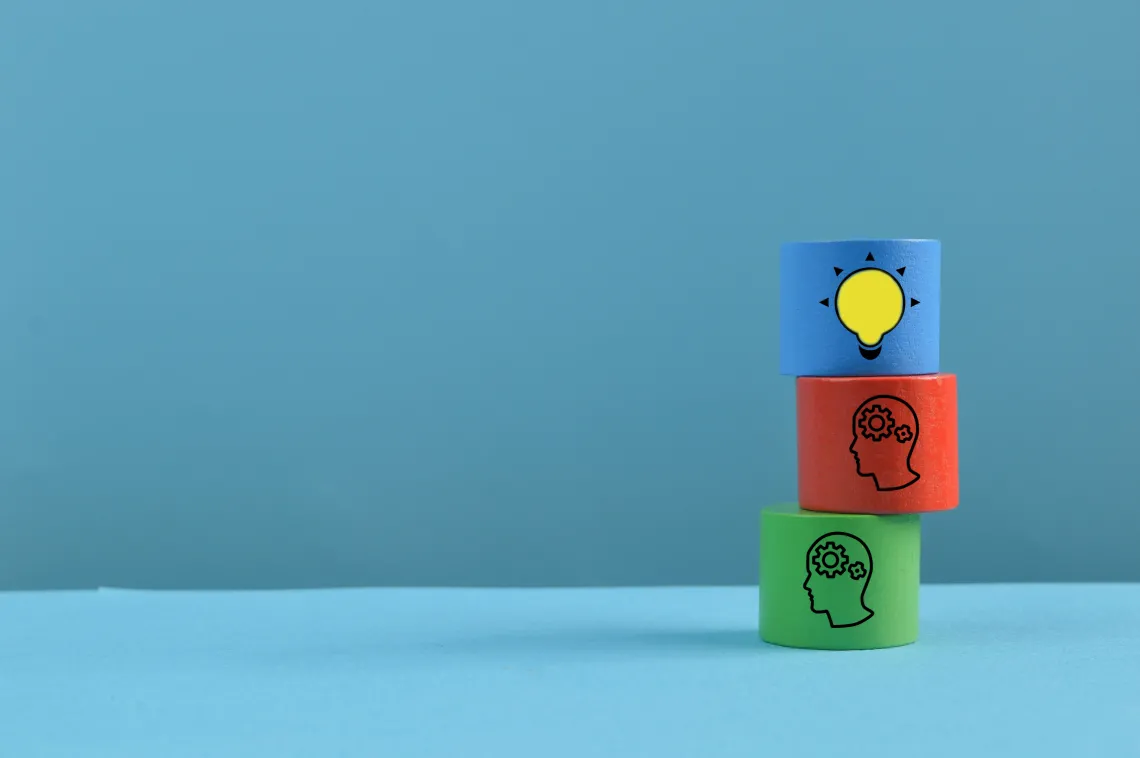 wooden colorful blocks with people and a light bulb