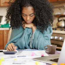 Woman doing bills in her kitchen